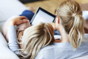 Two girlfriends using digital tablet